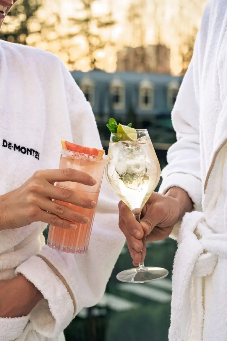 Couple in bathrobes sipping an aperitif at the QC Terme Milano.