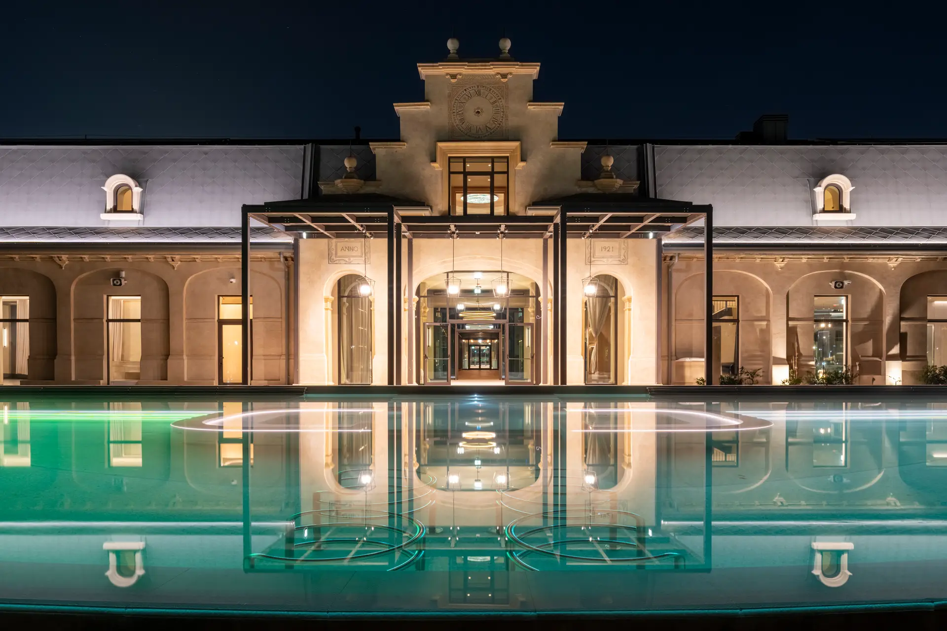 De Montel Terme Milan illuminated with reflecting pool at night